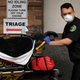 Medical workers bringing in patients to a special coronavirus intake area at Maimonides Medical Center in Brooklyn, New York, in April.